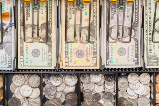 Top View of Cash Register Tray Filled with Money.