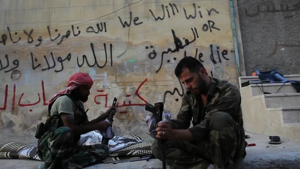 FSA rebels cleaning their AK47s in Aleppo, Syria during the civil war. Image credit: VOA News; Scott Bobb reporting from Aleppo, Syria