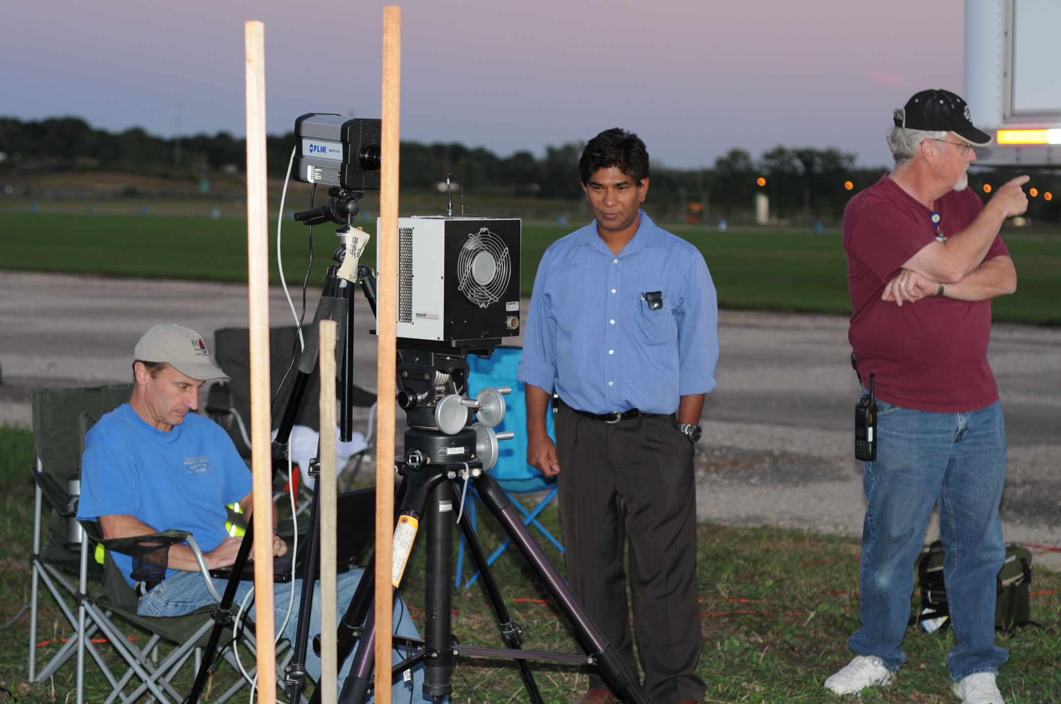 Jerome Zadnik, of EOIR Technologies and the National Geospatial Intelligence Agency; professor Mohammed Islam, of the University of Michigan and Omni Sciences, Inc.; and Bruce Smotherman, SAIC and Air Force Research Labs, conduct experiments with the laser using cameras and other diagnostic equipment at Wright Patterson Air Force Base. Image credit: Anthony Absi