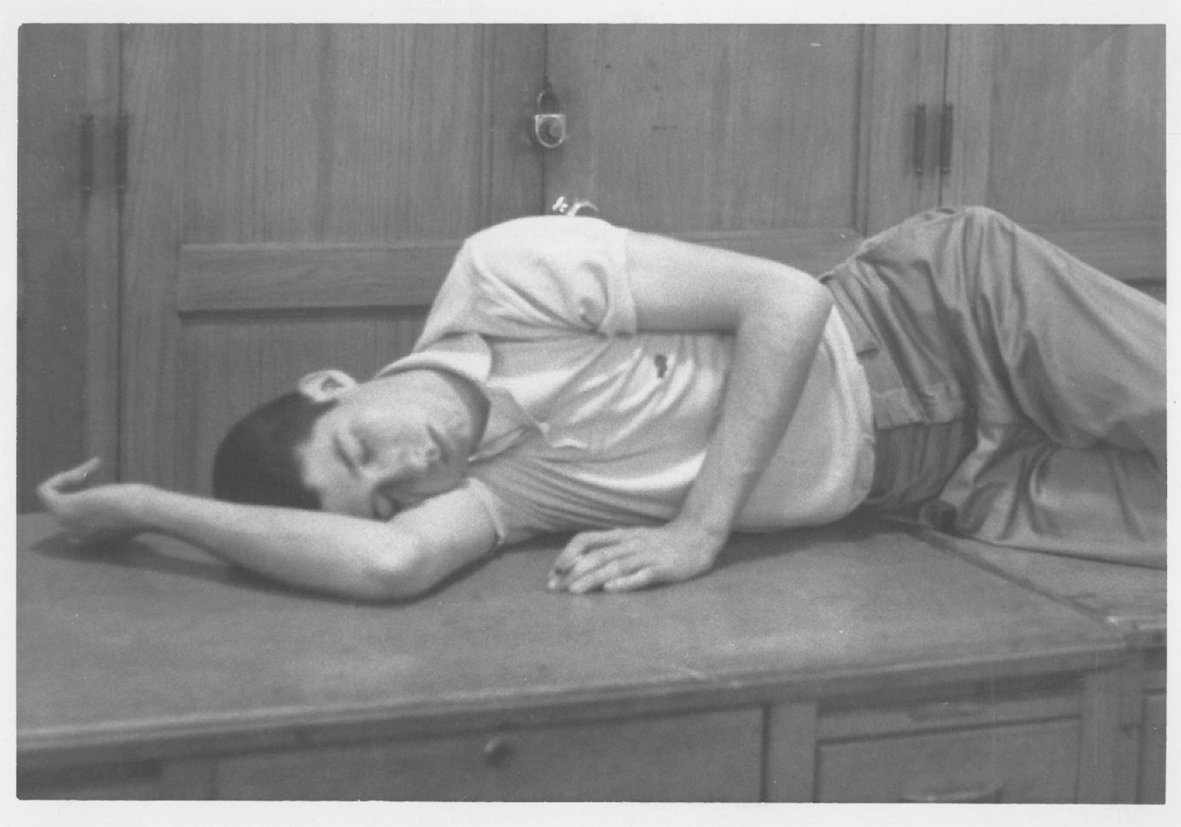 Student Tom Hayden asleep on a desk at the Michigan Daily, circa 1960. Image credit: Tom Hayden Papers held at the University of Michigan Library