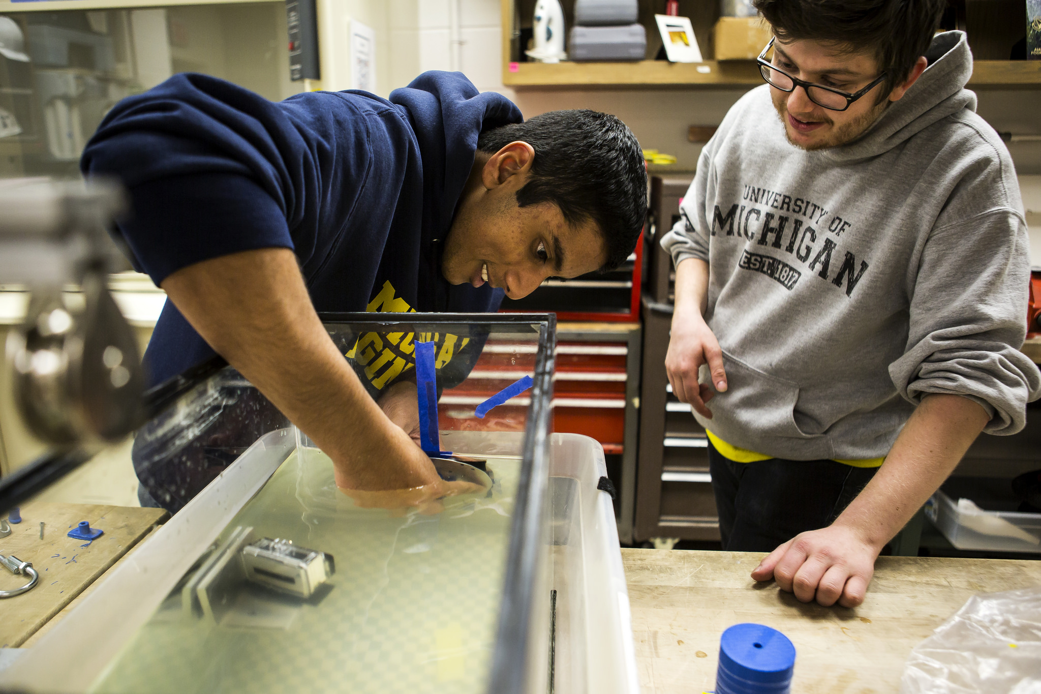 Siju Varughese, EE BSE Student, helps Steve West, AERO BSE Student, test the structure of small scale satellites (pico and femto sats) in the Space Research Building. Image credit: Joseph Xu, Michigan Engineering