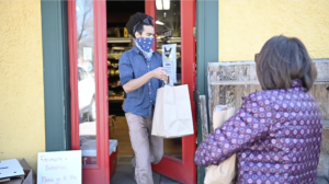 A customer picks up an online order at Argus Farm Stop on Packard. Image credit: Michigan Photography