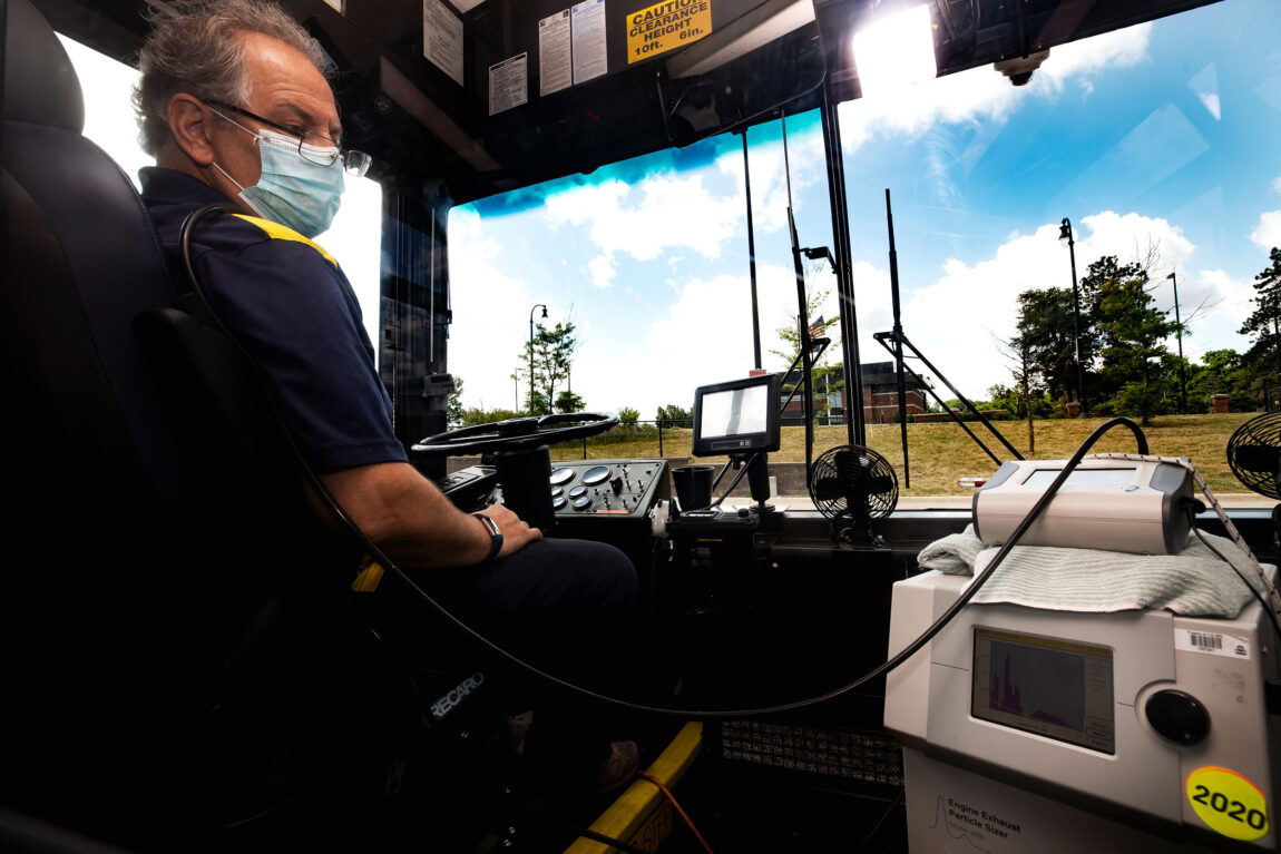 Photo of Andre Boehman, professor of mechanical engineering, and members of his research group testing for the flow of aerosols in a U-M bus. (Photo by Joseph Xu, College of Engineering)