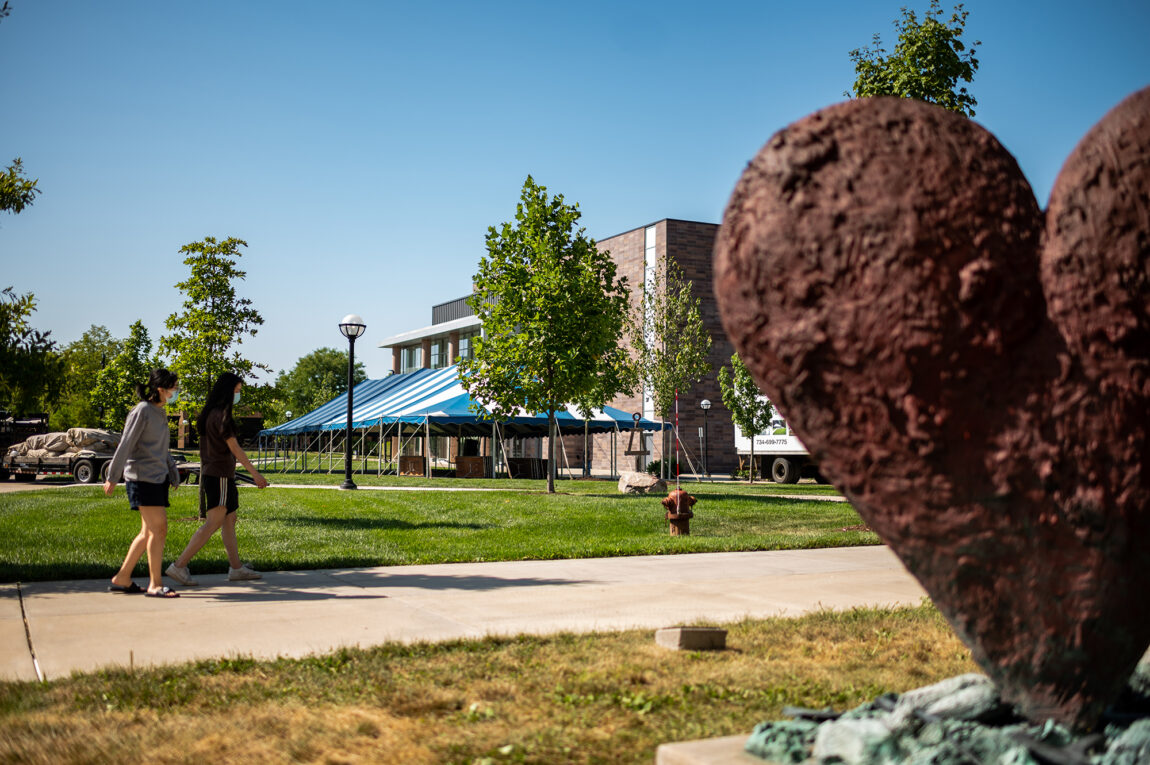 Photo of students walking near a canopy installed at The Grove on North Campus.