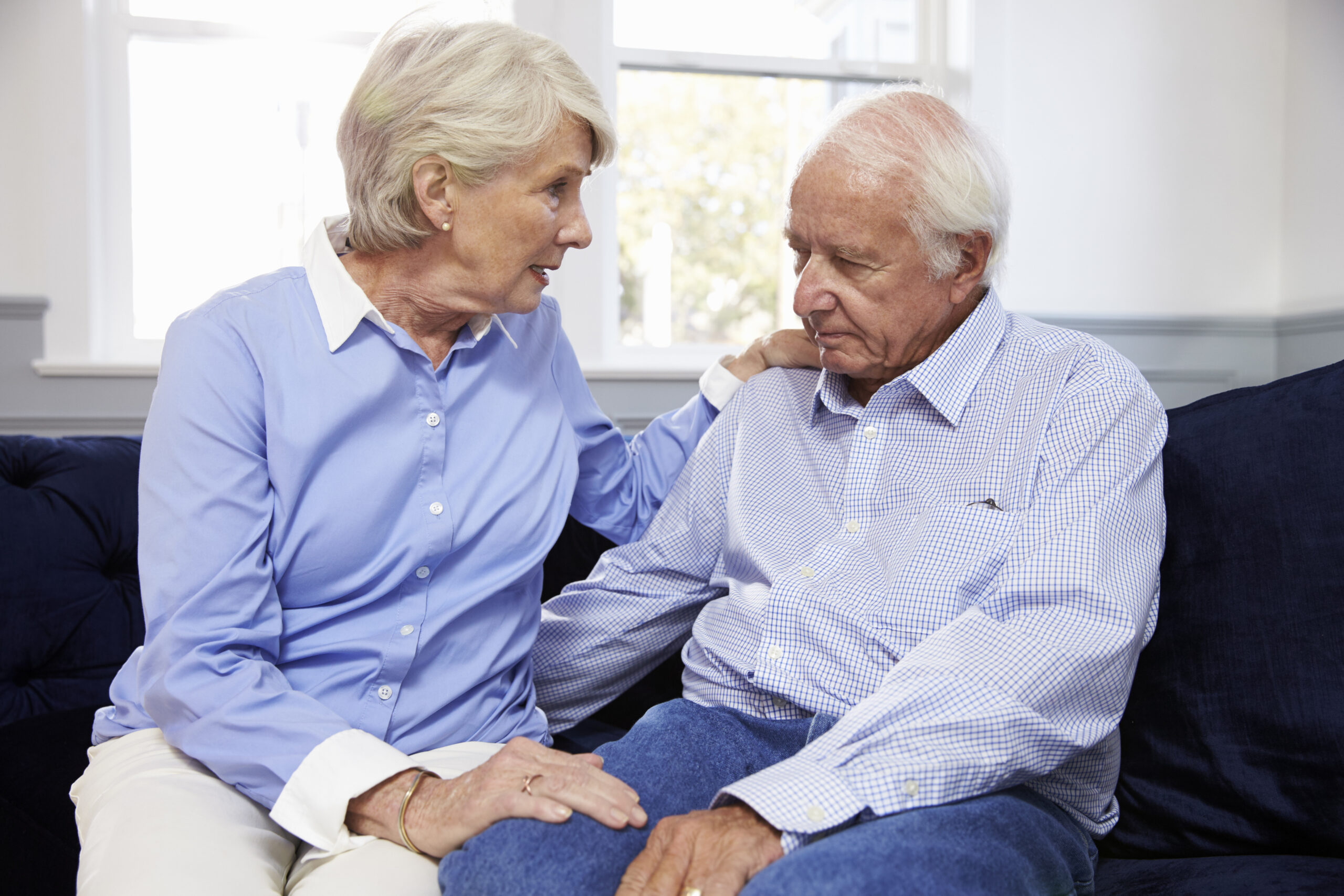 Wife Talking To Depressed Senior Husband At Home. Image credit: iStock