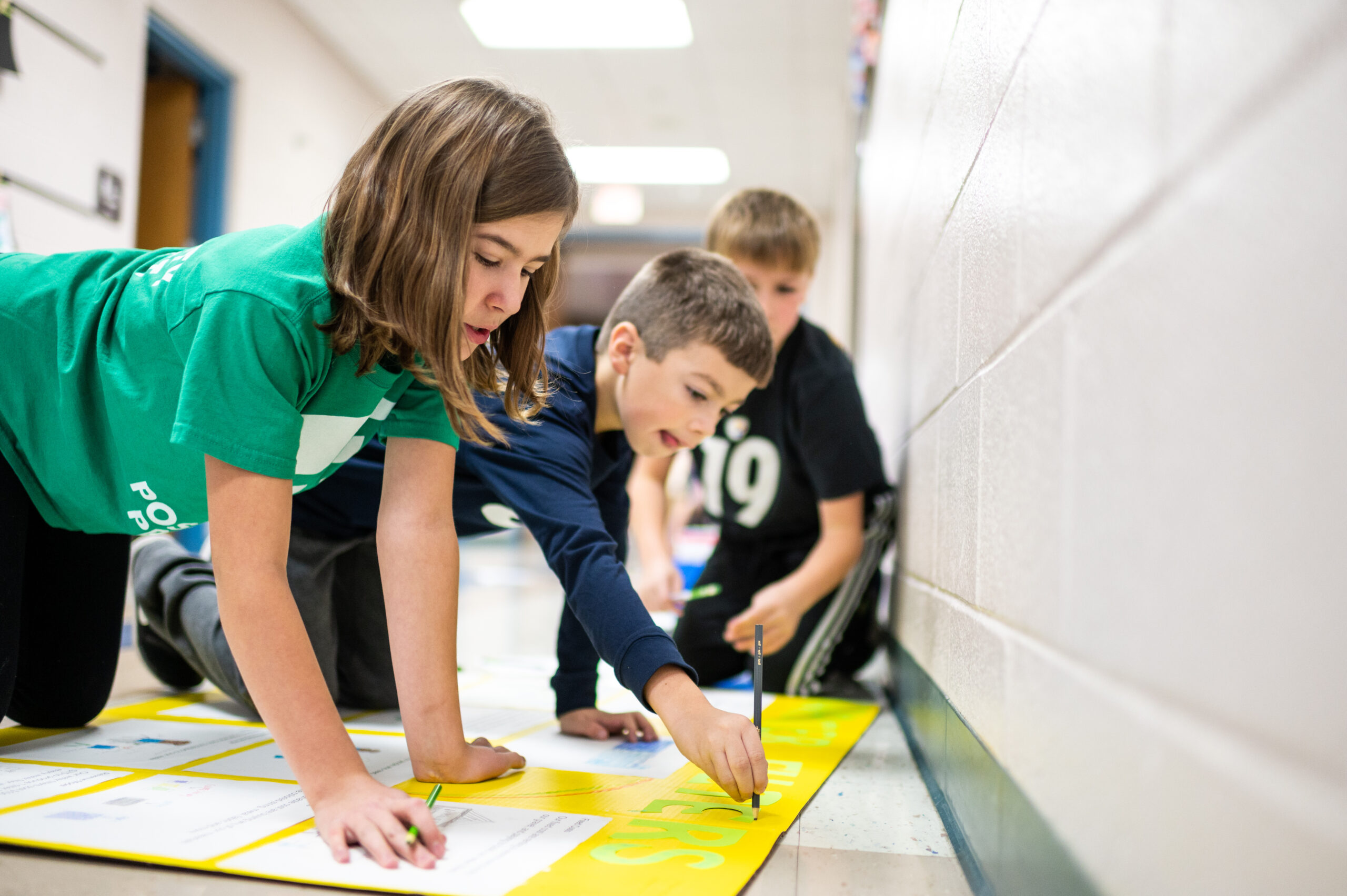 Students from Mason Elementary School of Grand Blanc Community Schools work on their Young Shark presentation. Image credit: Eric Bronson / Michigan Photography