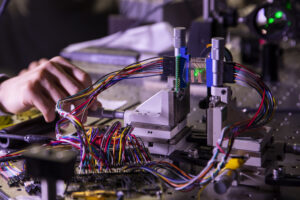 Zhen Xu, Graduate Student Research Assistant for Electrical Engineering and Computer Science (left) and Dehui Zhang, Graduate Student Research Assistant for Electrical & Computer Engineering measuring focal stack images of a point object simulated by focusing a green laser beam onto a graphene-based transparent photodetector array inside Ted Norris’ lab on North Campus in Ann Arbor, MI on January 27, 2021. Graphene detectors produce surprisingly high photoresponse while only absorbing a very small portion of light. U-M researchers are fabricating a prototype of transparent photodetector arrays to demonstrate its potential applications in 3D object tracking tasks used most commonly in autonomous driving and robotics. Image credit: Robert Coelius/Michigan Engineering, Communications and Marketing