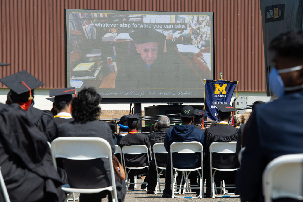 A small audience watches videos of commencement speakers at UM-Dearborn's ceremony for the College of Engineering and Computer Science graduates. (Photo by Austin Thomason, Michigan Photography)