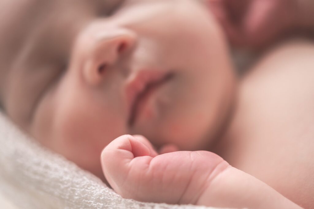 Out of focus close-up of a newborn baby. Image credit: Hu Chen, Unsplash.com
