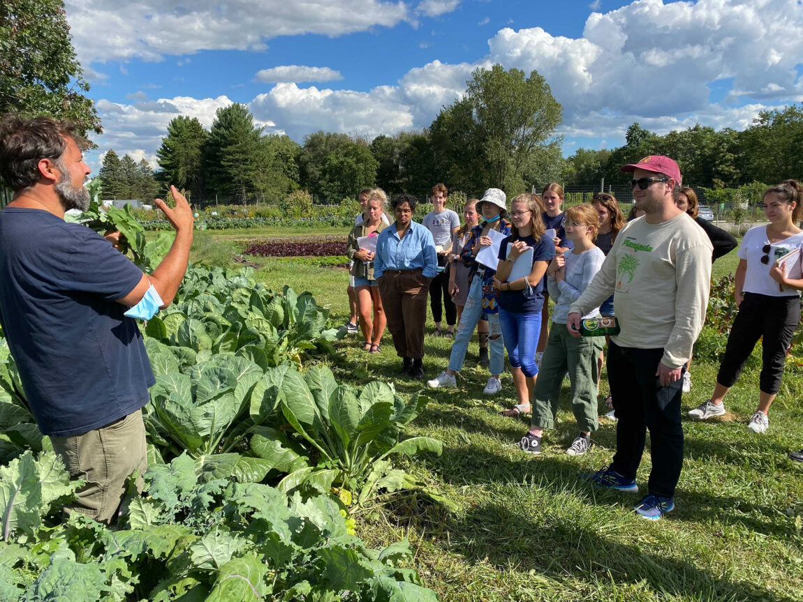 Jeremy Moghtader, left, program manager for the Campus Farm, addresses the Environ 465 class at the farm. (Photo by Becca Harley)