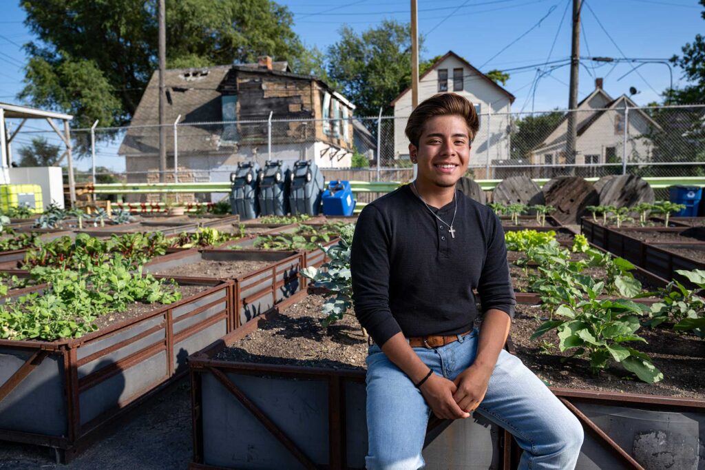 Yahir Hernandez, 19, started working at Cadillac Urban Gardens on Merritt four summers ago. He's now a sophomore at Michigan State University. Image credit: Eric Bronson, Michigan Photography