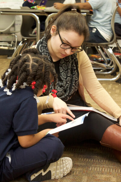 A student learns to read with a Michigan Alternate Route to Certification teacher. (Photo by Angela Marocco)