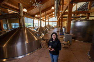 Lauren Torres, brewing manager at Bell's Brewery, enjoys an Official Hazy IPA at the office. Image credit: Eric Bronson, Michigan Photography