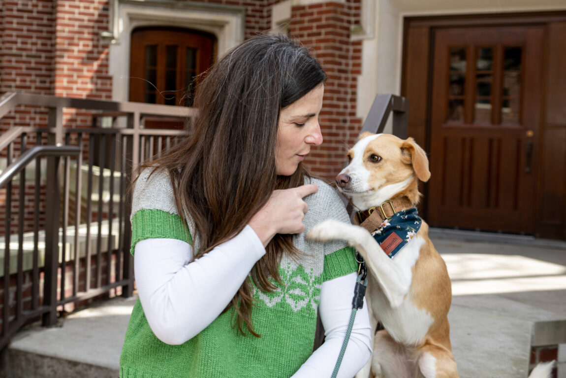 Sascha Crasnow, lecturer in Islamic arts and culture in the Residential College in LSA, shares a moment with Parker, her 2-year-old beagle-mix. Crasnow has helped teach Parker to “speak” through the use of nearly 100 buttons in her home. (Eric Bronson, Michigan Photography)