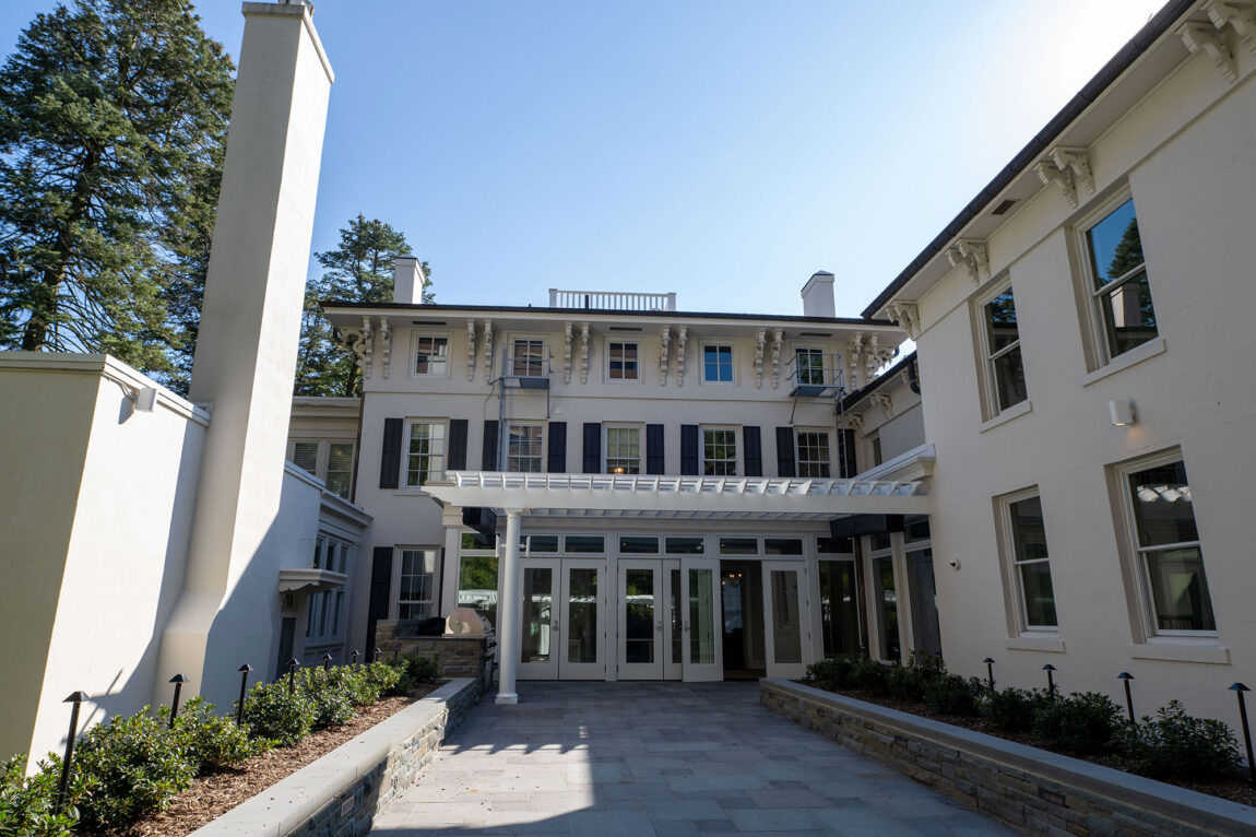 Photo of a bluestone patio leading to accessible doors at the rear of the President's Residence.
