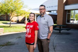 Catherine Vick, a 10th grader at Paw Paw High School and member of the cheerleading team, followed protocols developed by the University of Michigan to heal after she sustained a concussion at cheer practice, and her father John Vick. Image credit: Erin Kirkland, Michigan Photography
