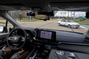 The Driverless May Mobility vehicle stops automatically to avoid collision and let the incoming car turn in front of it during the first day of testing to support the City of Detroit's Automated Driving System (ADS) Shuttle. The May Mobility engineer is AJ Weckle is behind the wheel but not steering the shuttle van. Image credit: Marcin Szczepanski/Lead Multimedia Storyteller, Michigan Engineering