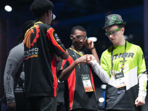 Student Tyre Ramey, center, said the experience competing in Houston was memorable and fun "being able to be a part of a robotics community." Image credit: Elizabeth Conley, special to Michigan Photography.