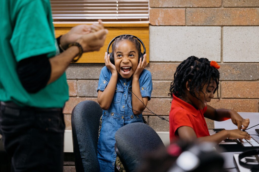 A student reacts while listening to their creation during music production class at Crescendo Detroit, an after-school program for children ages 5 to 18 that develops music and dance programming to promote artistic excellence and character building. Image credit: Erin Kirkland, Michigan Photography