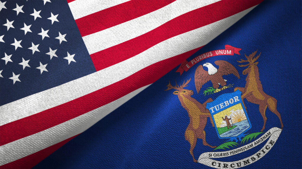 Michigan state and United States flags together. Image credit: iStock