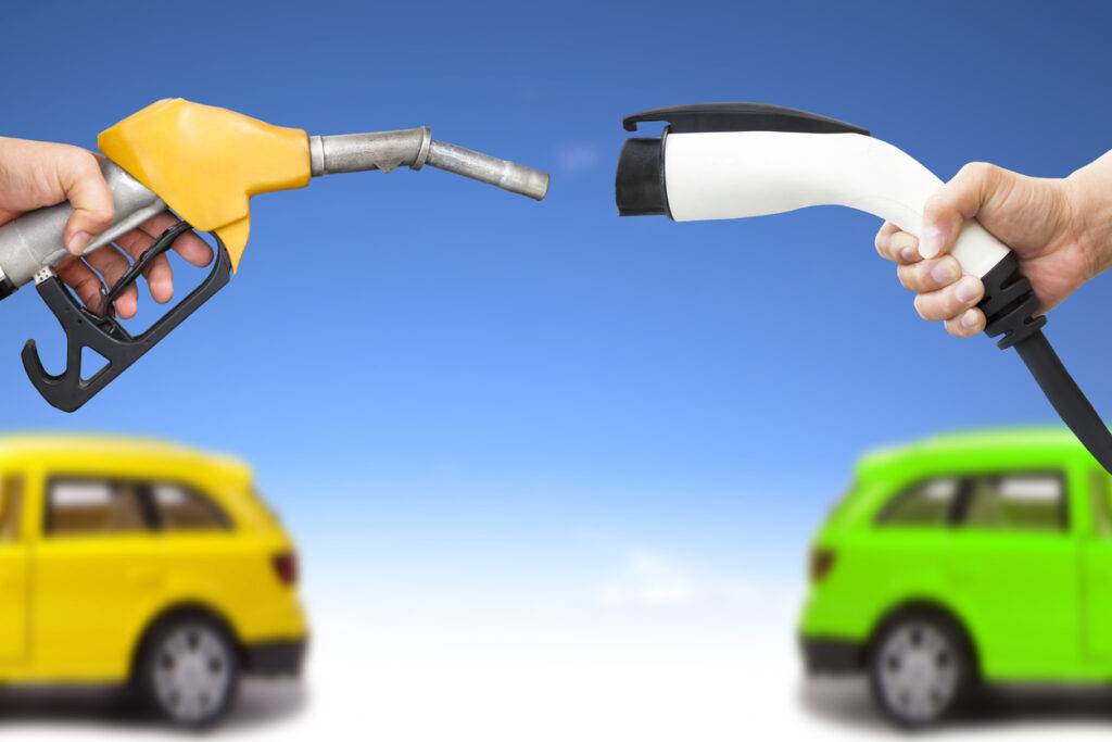 Concept illustration of a gas pump vs. a power connector for an electric vehicle. Image credit: iStock