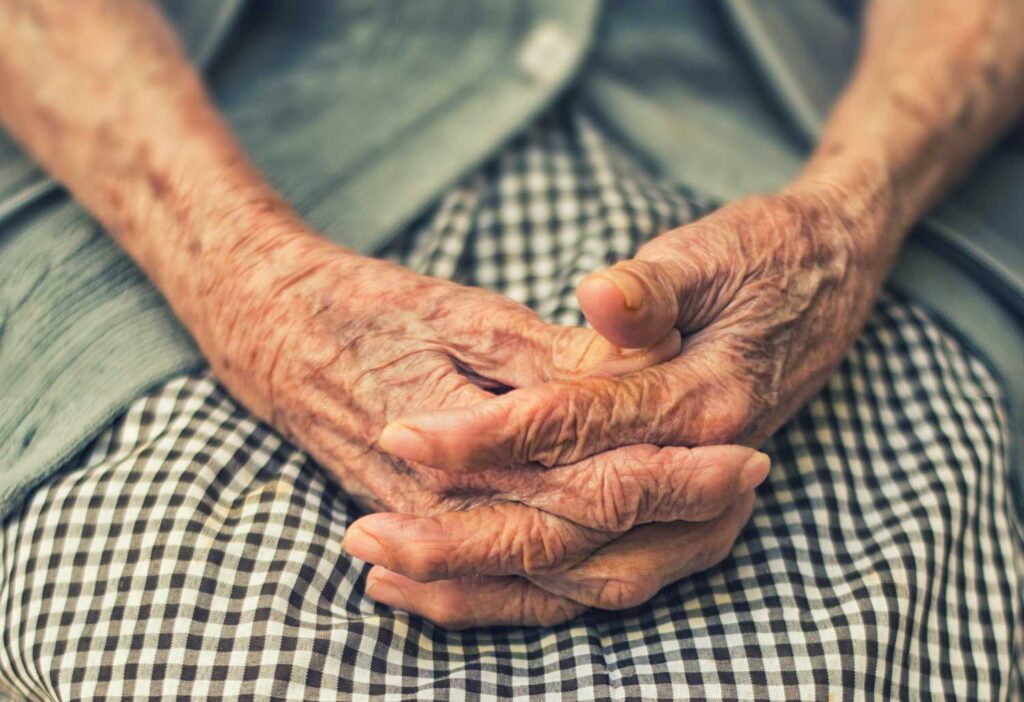 A woman's elderly hands in her lap. Image credit: Danie Franco, Unsplash