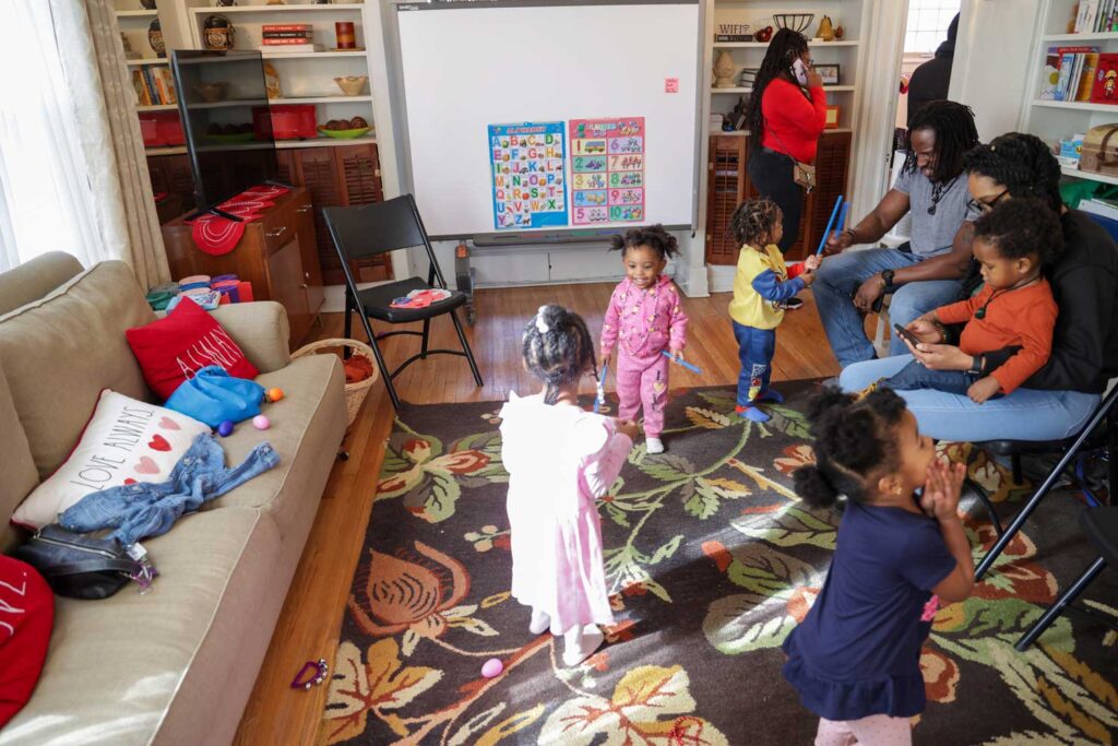 Toddlers converge in the living room at Brilliant Detroit's Martin Park hub for play time. Parents stay for the whole session and share parenting experiences. Image credit: Jeremy Marble