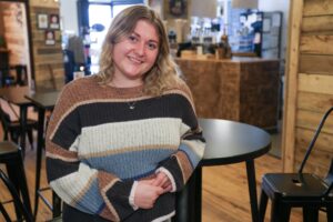 Shaylee Menhennick, a U-M graduate, stops for a coffee at Campfire Coffee on a recent trip home to Negaunee. Image credit: Jeremy Marble