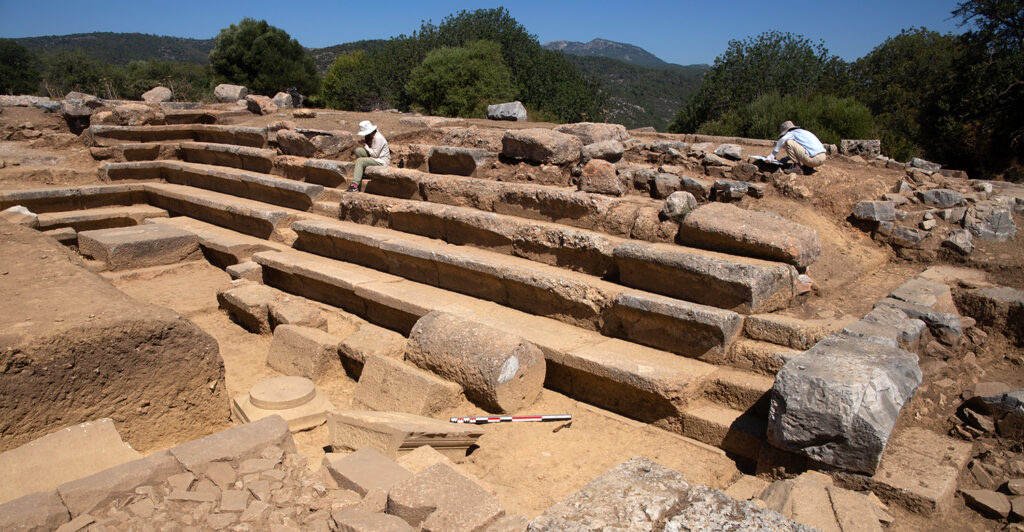 Architects Kübra Sağlam and Gizem Seymen working on architectural drawings of Bouleuterion, view looking northwest. Photo Credit: Notion Archaeological Project, University of Michigan