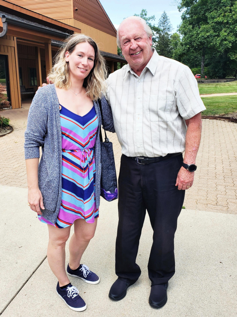 A photo of a woman and a man standing together on a sidewalk