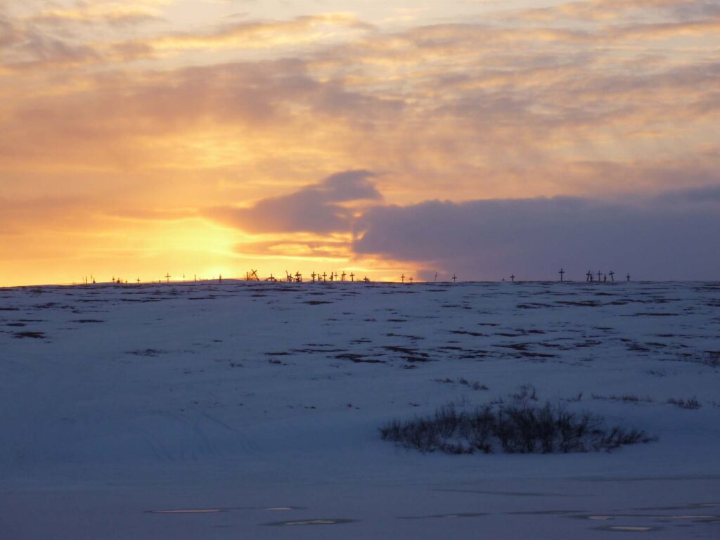 A cemetery on a hill at sunset in a remote Alaskan community. Images courtesy: Lisa Wexler