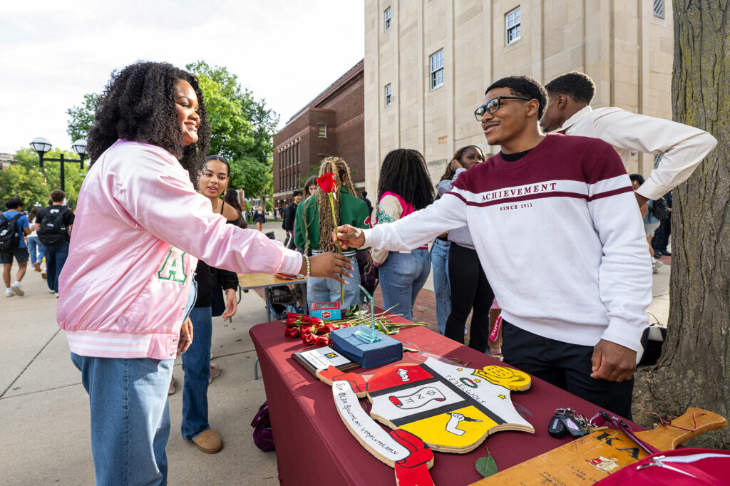 Savaun Jones-Kappa of Alpha Psi Fraternity, Inc. speaks to a visitor at the Central Campus Festifall.
