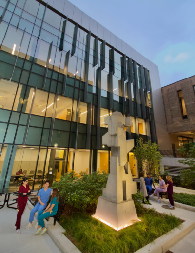 A glass wall of a four-story addition at the School of Dentistry
