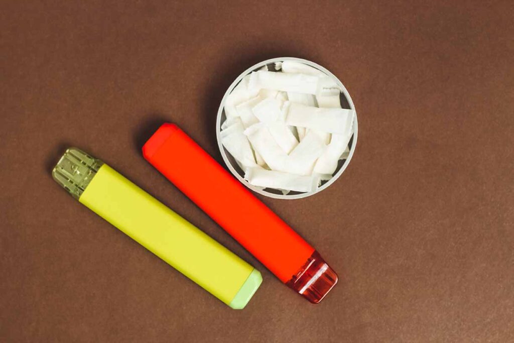 Nicotine pads snus, cigarette replacement, together with an electronic cigarette. Image credit: Adobe Stock