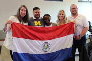 Javier Franco Duarte poses with the Paraguayan flag together with U-M students and faculty members. Image credit: Juan Ochoa