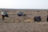 Carrying the sifted dirt to the only available shade from the vehicles. There are no trees around here for use as shades. Image credit: Yohannes Haile-Selassie