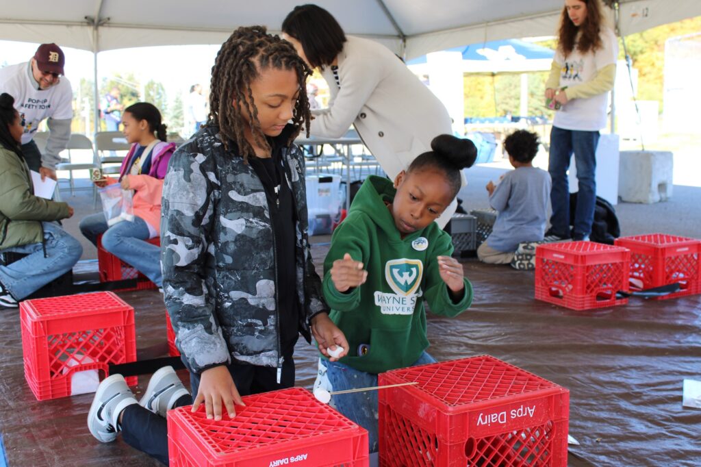 Kids are working together in pairs to build a bridge out of spaghetti and marshmallows. Image credit: Juan Ochoa