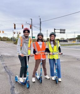 U-M student assistants are posing at MCity on scooters for the Pop-up Safety Town initiative. From left to right: Saketh Addanki, Dylan Hogan and Ava Rawley. Image courtesy: Andrew Hashikawa