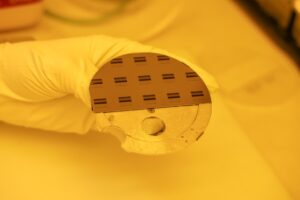 A 100 mm silicon wafer that has been partially cleaved and is mounted onto a scanning electron microscope holder. Image credit: Jeremy Marble, Michigan News