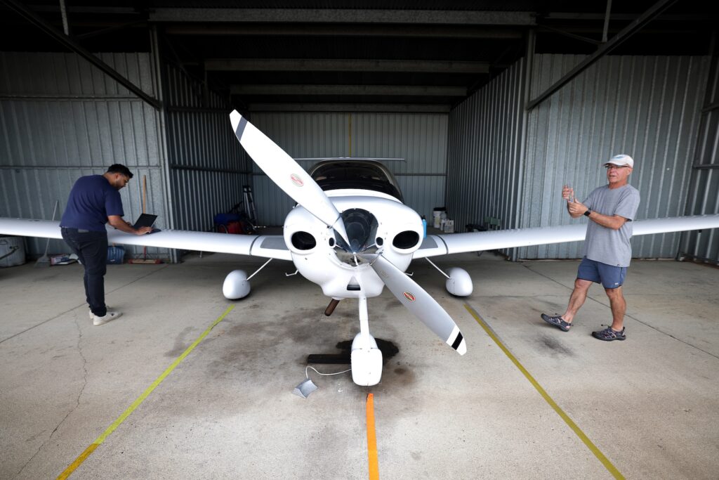 Rohan Madathil (left), a Master's graduate in climate and space sciences and engineering and co-author of the study, and Nilton Renno (right), a professor of climate and space sciences and engineering, prepare the infrared sensor for a test flight on Renno's personal plane. Image credit: Brenda Ahearn, Michigan Engineering.