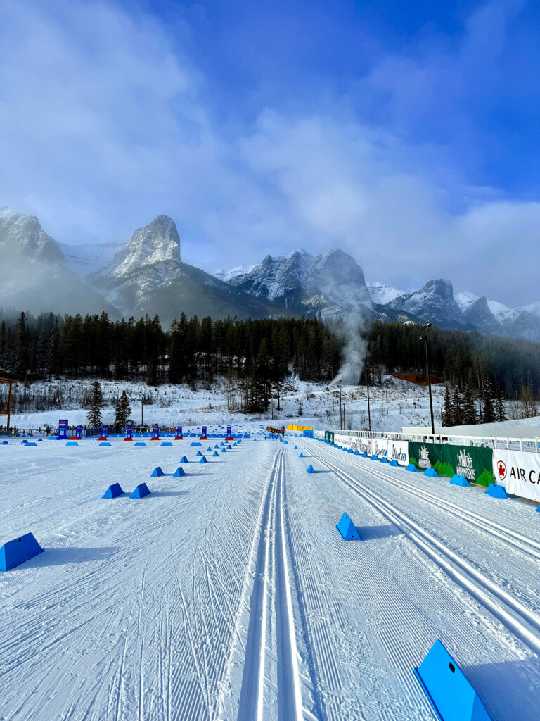 A cross country ski track with mountains in the background