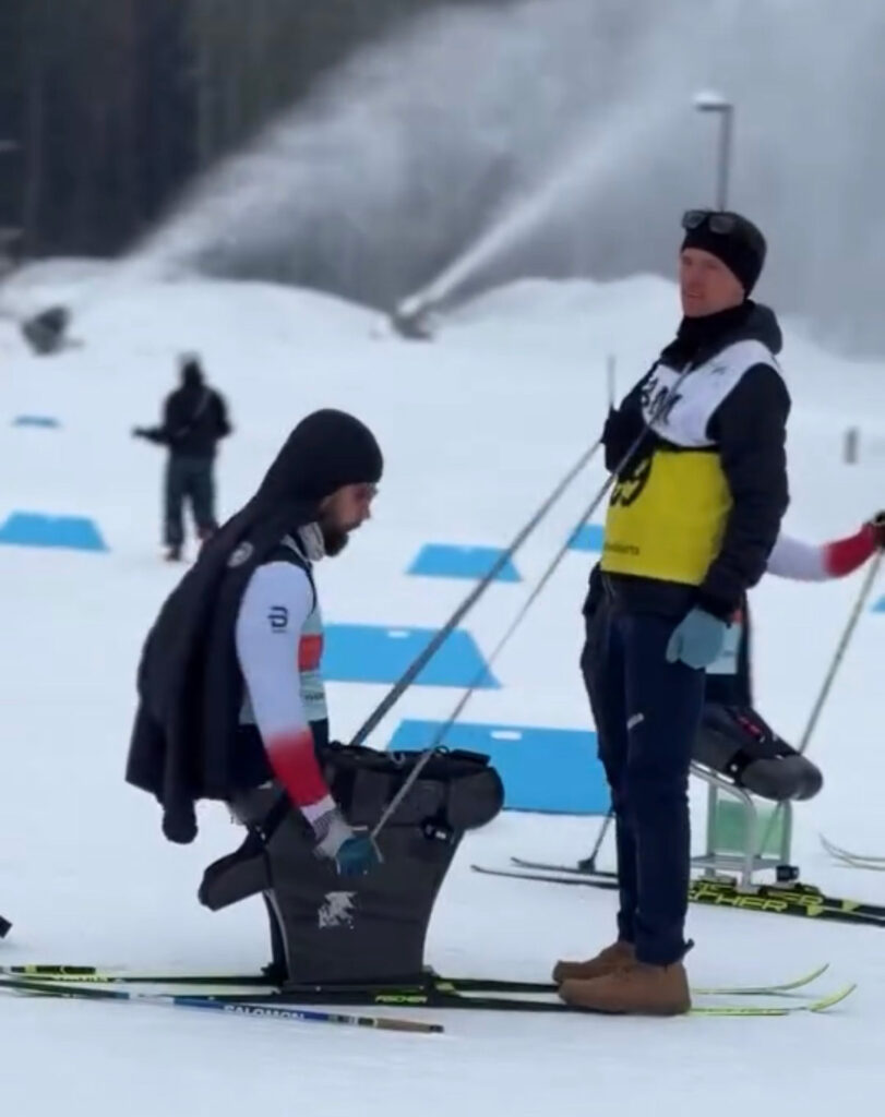Two men in winter ski gear outside on a ski slope