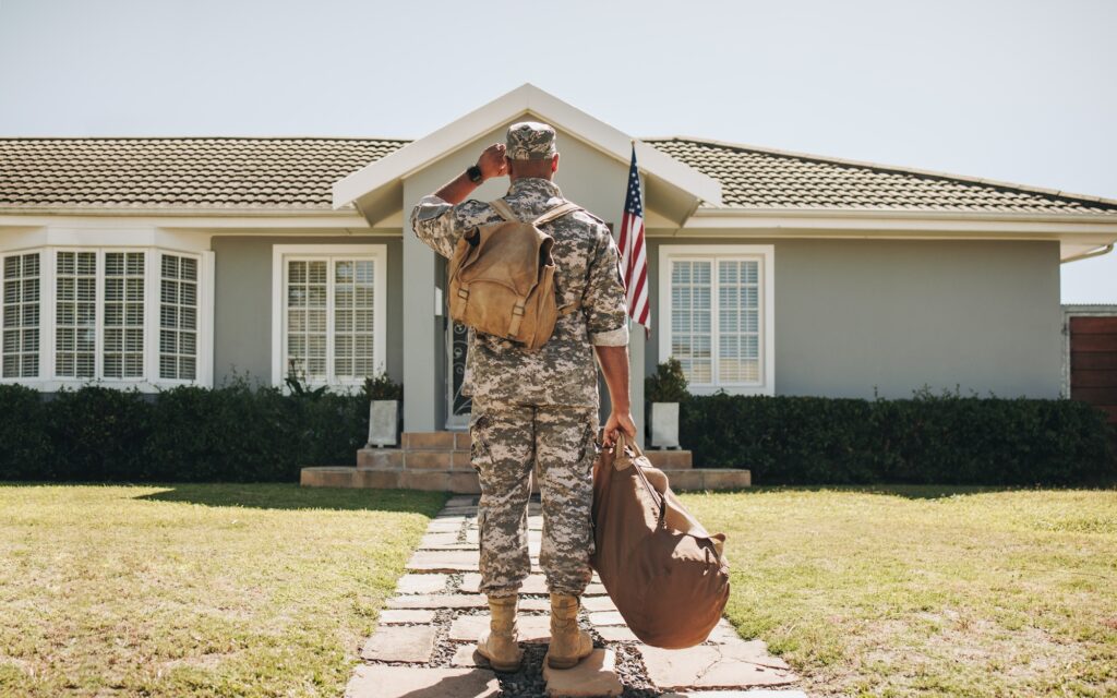 Rearview of a soldier returning home from the army. Image credit: Adobe Stock