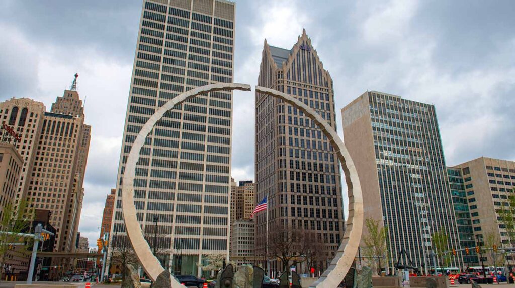 Transcending arch monument at Hart Plaza with One Woodward Avenue building and Ally Detroit Center at background in downtown Detroit, Michigan. Image credit: Adobe Stock