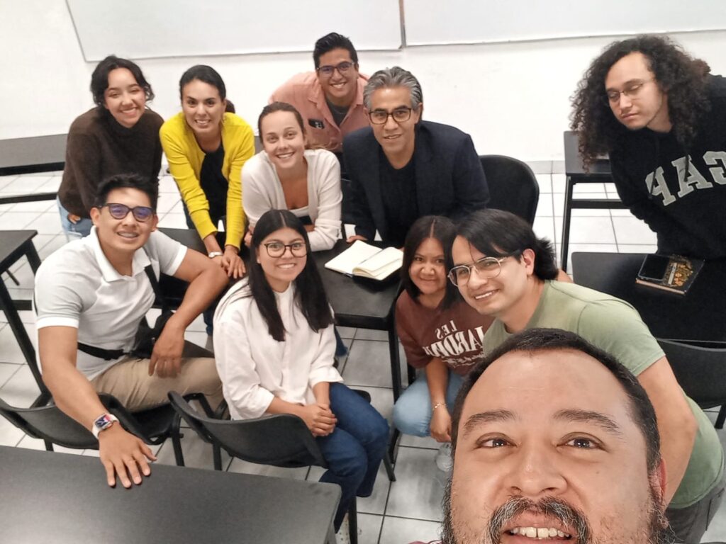 Ava with her graduate students and professor colleagues in an English class.