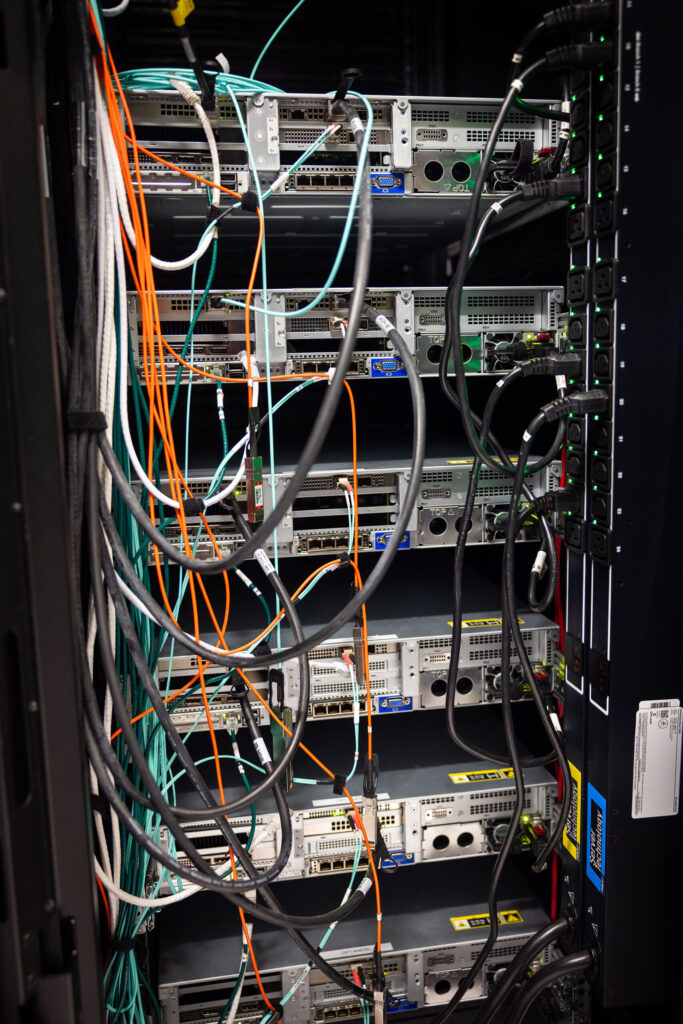 Computer server with multiple wires coming out of it.