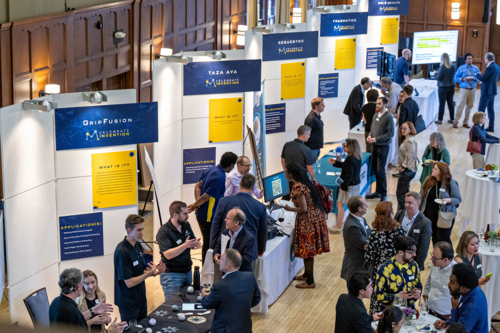 Conference style event with people interacting with vendors at tables