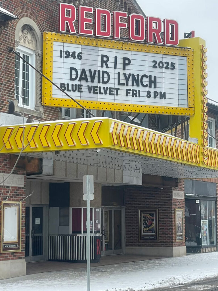 A photo of Detroit’s Redford Theatre, with the marquee advertising the cult film “Blue Velvet."