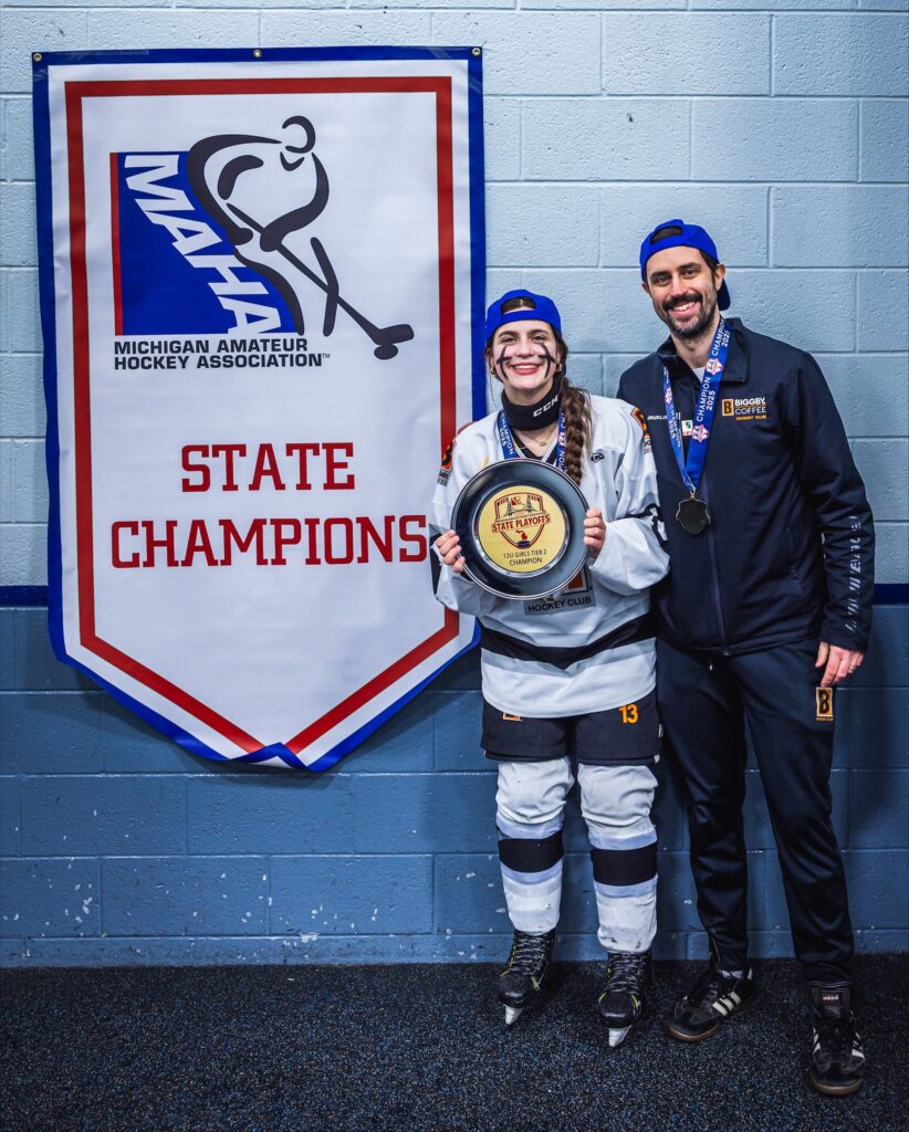 Photo of Bernard Marini and his daughter after winning a hockey championship