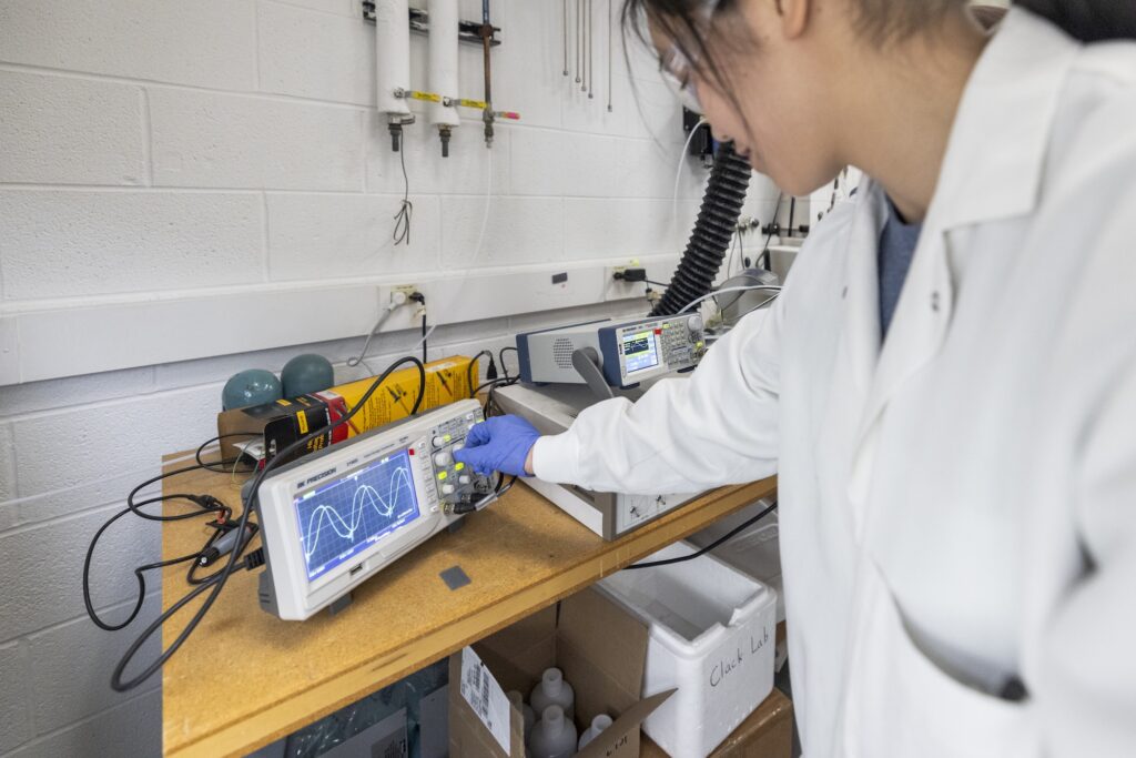 Emily Hong, PhD precandidate in civil and environmental engineering, adjusts the knobs on a piece of lab equipment in professor of civil and environmental engineering Herek Clack’s lab at the G.G. Brown Laboratory on North Campus at the University of Michigan. Image credit: Gabi Iriarte/Michigan Engineering, Communications & Marketing